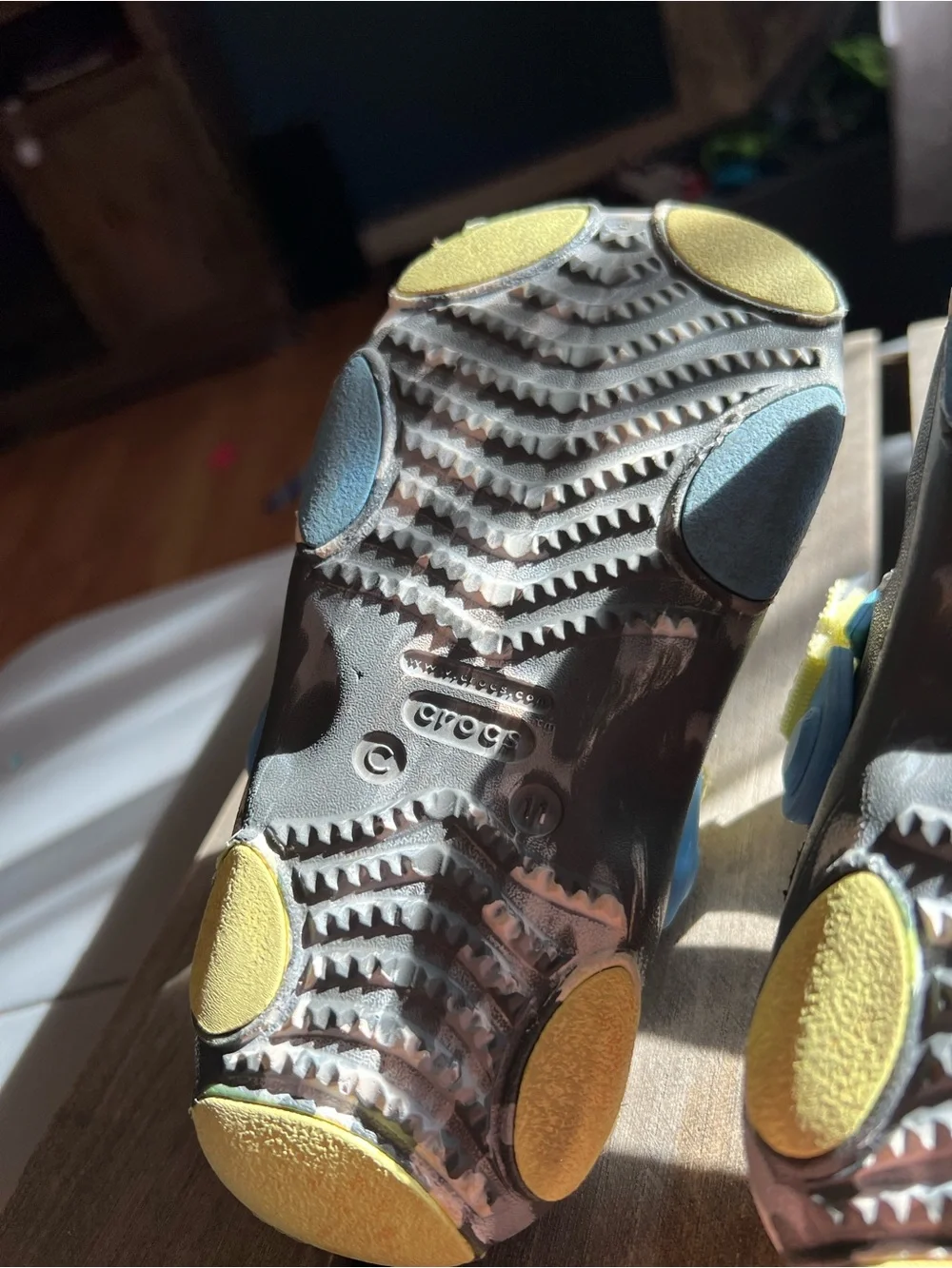 CROCS Kids Black Sandals with Blue and Yellow Accents